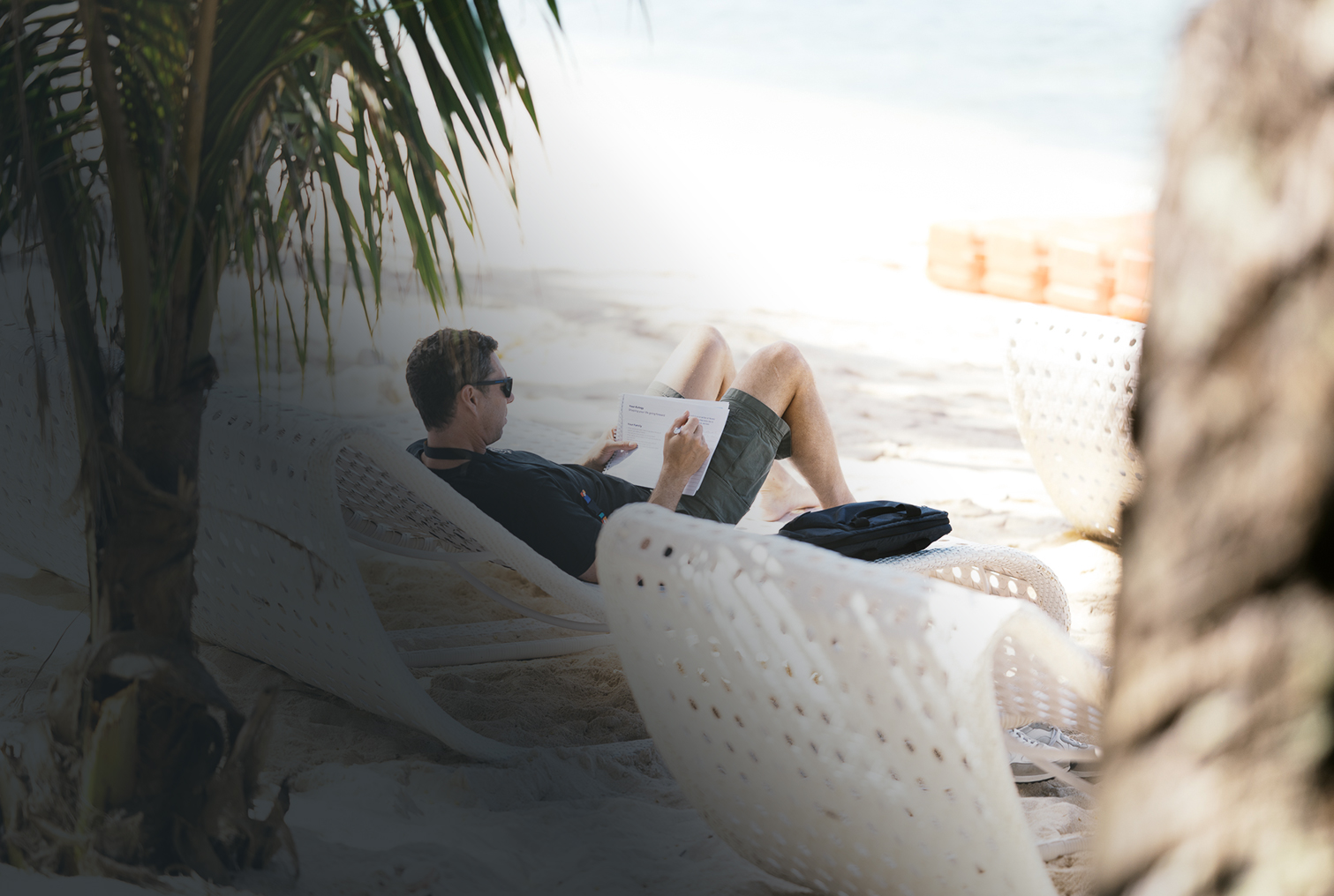 Attendee working through his workbook on the beach
